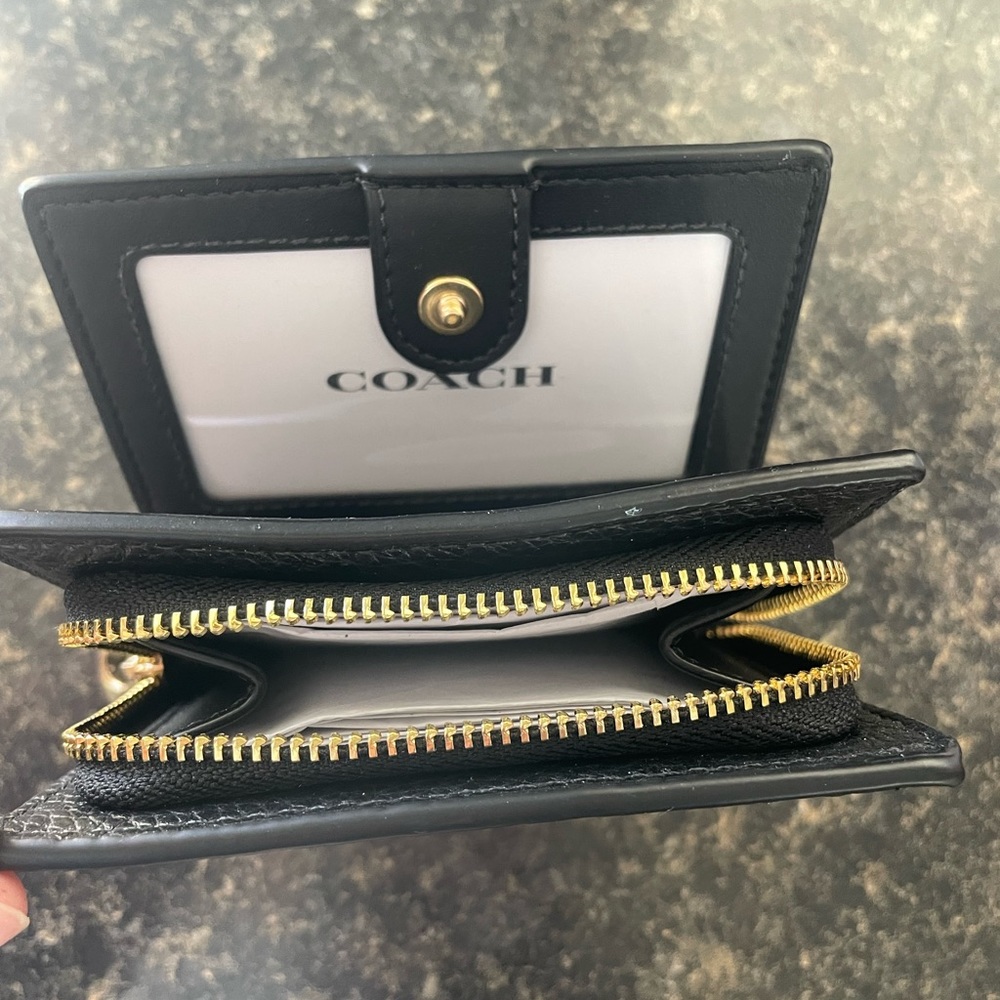 New black and gold Coach snap wallet.